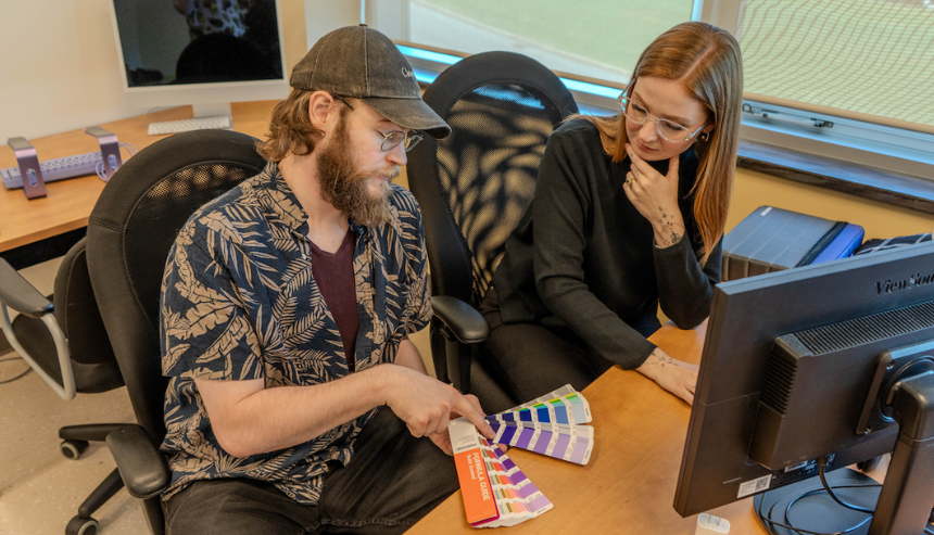 Research Assistant, Lex van Es (left), and BCIC Research Lead Sarah Godfrey (right) review a colour swatch at a computer desk.
