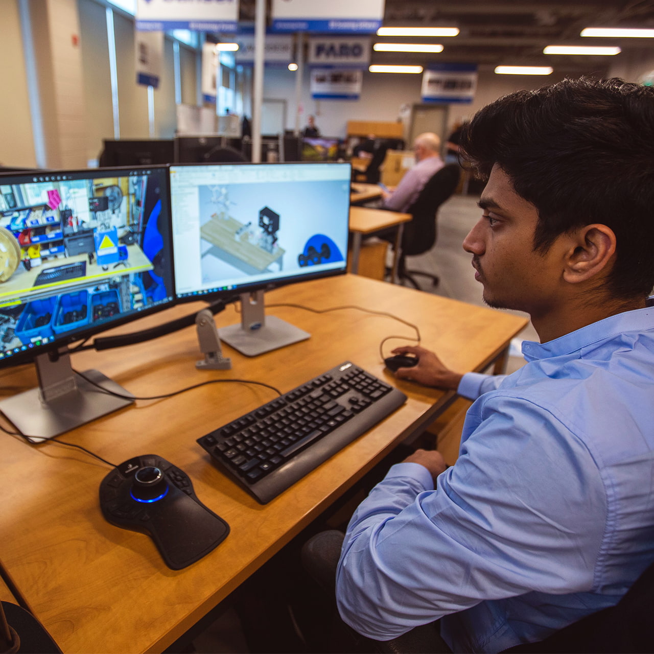 http://Student%20working%20on%20dual%20monitor%20computer