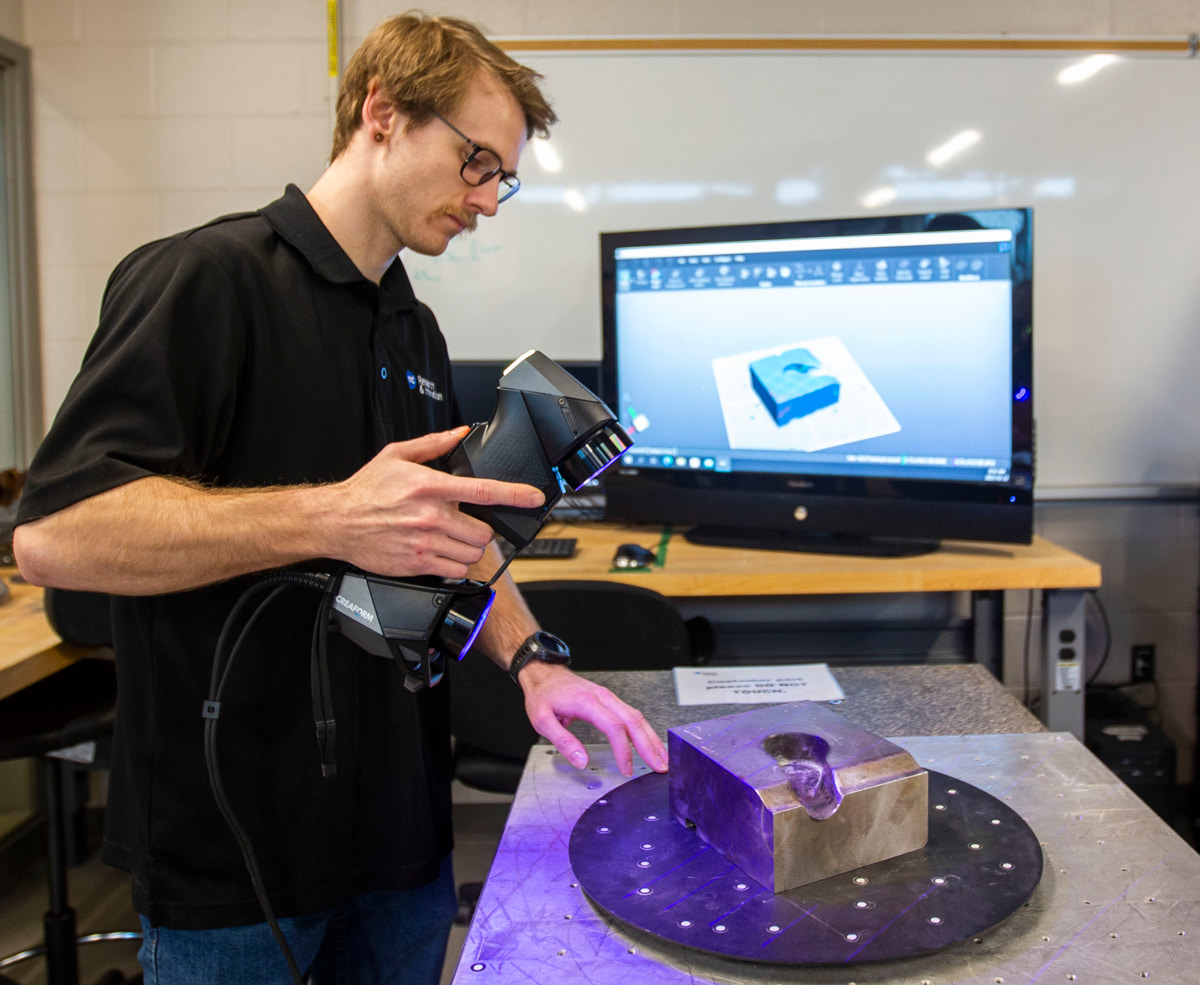 Brock Husak at WAMIC scanning a part