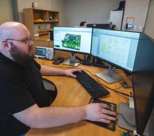 Researcher in WAMIC lab working on computer