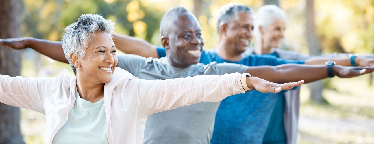 http://Senior%20men%20and%20women%20doing%20a%20yoga%20pose%20outside%20in%20nature.