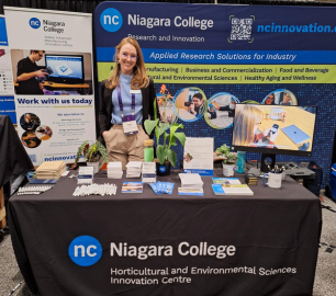 Ashley Paling with the Research and Innovation's booth at DiscoveryX conference in Toronto.