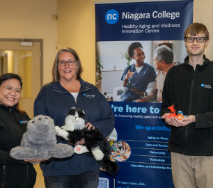 HAWIC team holding robotic pets