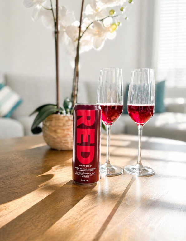 RED can sitting on a dining room table and poured into two champagne glasses