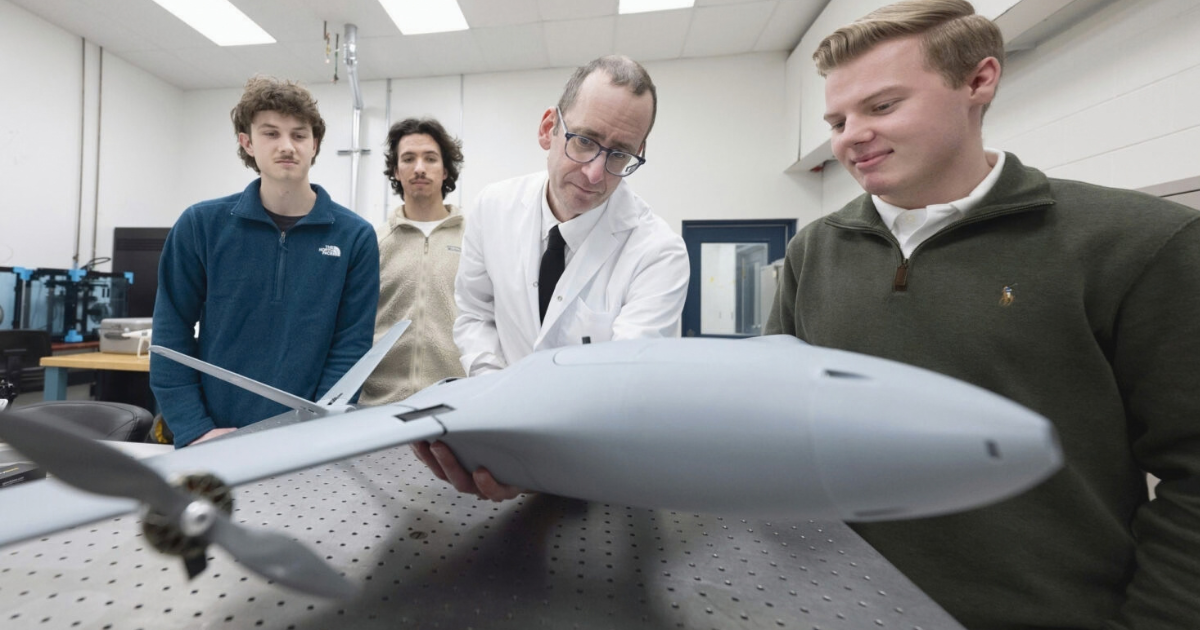 http://Students%20and%20Program%20Coordinator%20Alexander%20McGlashan%20inspect%20a%20fixed%20wing%20drone%20(UAV)%20manufactured%20at%20Niagara%20College.